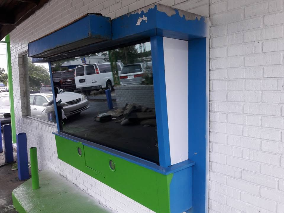 Commercial storefront window treated with dark solar control film