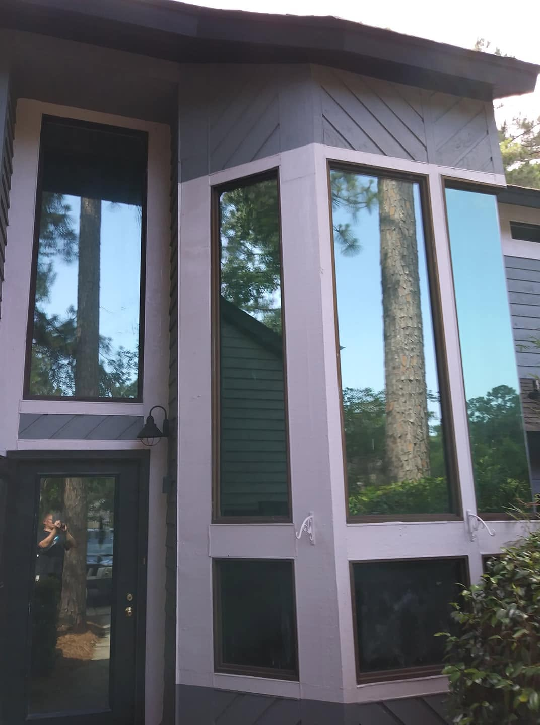 Two-story home with tall windows treated with residential window film