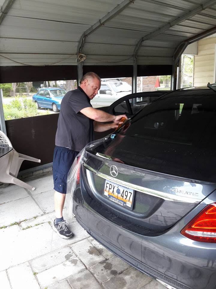 ACE Custom Tint owner applying professional window film